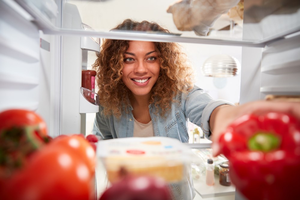 Woman looking into fridge for something to eat