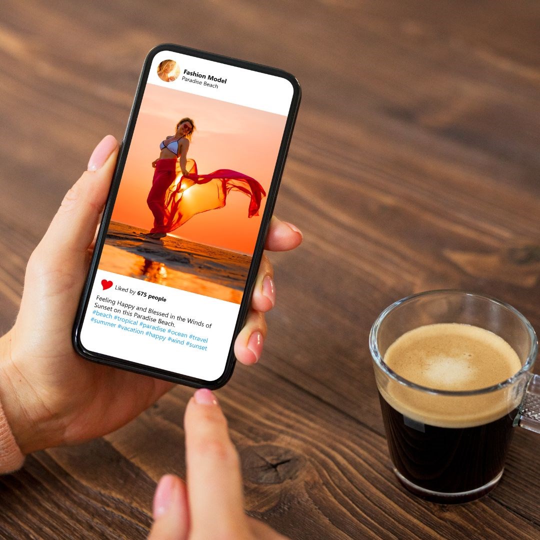There is an image of someone on Instagram on their phone with a cup of coffee next to them