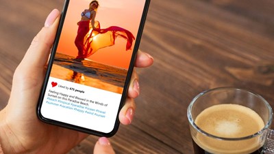 There is an image of someone on Instagram on their phone with a cup of coffee next to them